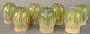 Set of Seven Tiffany Shades, floriform with opalescent green and gold pulled feather design, all marked L.C.T. height 5 inches, diameter 3 1/4 inches.