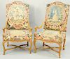 Pair of Louis XIV Needlepoint Upholstered Walnut Armchairs, shaped crest with open scroll arms, over cabriole legs ending in hoof feet, all carved wit