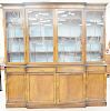 George IV style mahogany breakfront in two parts with four glazed doors on base with four drawers and four doors. ht. 96 in., wd. 98 in..