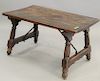 Spanish Walnut Low Folding Table, having iron supports and slab top, 16th century to early 17th century, height 18 in., top 19 x 32 in.