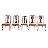 Lote de 5 sillas. Siglo XX. Estilo Chippendale. En talla de madera. Una con diseño diferente. Con asiento en tapicería marrón y ocre.