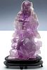AN ASIAN AMETHYST HARDSTONE CARVING OF SCHOLAR
