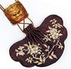 A JAPANESE EMBROIDERED PURSE WITH MYTHICAL MASK SLIDE