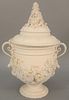 Large Bisque covered urn having two handles and molded flowers. ht. 18 in., wd. 13 in. Provenance: The Estate of Ed Brenner, Short Hills N.J.