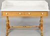 Pine wash stand with marble top. ht. 33 1/2 in., wd. 48 in. Provenance: Former home of Mel Gibson, Old Mill Rd, Greenwich, CT