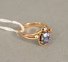 14 karat gold ring set with oval blue sapphire, approximately 1.25 cts. and three smal diamonds, 5.3mm x 6.5mm. size 5.
