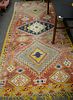 Three piece lot to include Moroccan oriental area rug. 5' x 11' 4", along with two Oriental throw rugs 2' 5" x 3' 10" and 5' x 7' 5". Provenance: Form