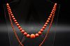 A CORAL BEAD NECKLACE, of graduating polished coral beads, strung knotted o