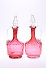 A PAIR OF CRANBERRY GLASS DECANTERS, LATE 19th CENTURY, each with clear gla