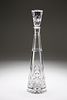 A CUT-GLASS SPIRE DECANTER, the tapering stopper with foliate band over a p
