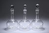 A SET OF THREE VICTORIAN GLOBE DECANTERS, each with ribbed body and panelle