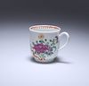 A WORCESTER POLYCHROME FLORAL PAINTED COFFEE CUP, c. 1770, painted with a r
