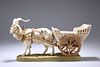 A ROYAL DUX MODEL OF A HARNESSED GOAT AND CART, modelled upon a grassy base