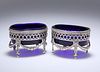 A PAIR OF GEORGE III STYLE SILVER-PLATED SALTS, each oval, the pierced body