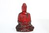 A CHINESE MODEL OF A SEATED BUDDHA, POSSIBLY CHERRY AMBER. 18cm