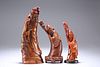 THREE CHINESE CARVED HORN FIGURES, 19TH CENTURY, each modelled holding a st
