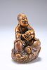 A CHINESE CARVED SOAPSTONE FIGURE OF A SEATED LOHAN, 19TH/20TH CENTURY, on 