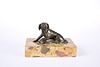 A 19th CENTURY DESK BRONZE OF A SEATED DOG, modelled with a paw on a sack, 