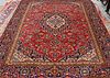 A KASHAN CARPET, with a central medallion within a blue ground medallion, a