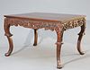 A CHINESE CARVED HARDWOOD TABLE, CIRCA 1900, the square top above a frieze 