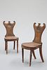 A PAIR OF REGENCY MAHOGANY HALL CHAIRS, with paired C-scroll crests above a