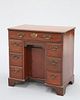 A GEORGE III MAHOGANY KNEEHOLE DESK, the moulded rectangular top with inver