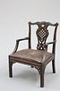 A MAHOGANY OPEN ARMCHAIR, IN THE IRISH CHIPPENDALE TASTE, the crest rail ce