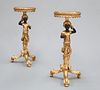 A PAIR OF BLACKAMOOR FIGURAL STANDS, each circular top with leaf moulded ed