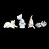 Four Playful Porcelain Cat Figurines