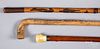 Two carved canes, together with a bone grip cane.
