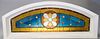 Victorian leaded glass transom window white painted wooden casing, curved top, yellow and blue glass with medallion at center and jewels, two cracked 