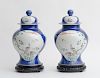 PAIR OF CHINESE BLUE-GROUND FAMILLE ROSE PORCELAIN BALUSTER-FORM JARS AND COVERS
