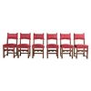 Lote de 6 sillas. Siglo XX. En talla de madera. Con respaldos semiabiertos y asientos acojinados en tapicería color vino.