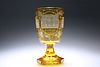 A GERMAN AMBER GLASS GOBLET, 19th CENTURY, the bowl etched with named archi
