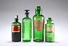 FOUR LATE VICTORIAN GREEN GLASS APOTHECARY BOTTLES, with moulded ribbed bod