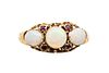 A MID 19TH CENTURY OPAL AND RUBY RING
 Set with a trio of circular and oval