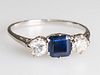 A SAPPHIRE AND DIAMOND RING
 The square cut sapphire between two brilliant 