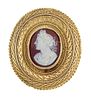 A HARDSTONE CAMEO BROOCH
 The oval plaque, carved 