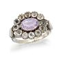 AN AMETHYST AND PASTE CLUSTER RING
 The oval-cut a