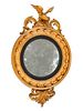 A Regency Style Giltwood Convex Mirror
Height 38 x width 23 1/2 x depth 5 1/2 inches.
