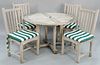 Five piece teak outdoor lot to include a round teak table and four Kingsley Bate chairs with custom cushions, dia. 47".