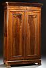 French Louis Philippe Carved Walnut Armoire, 19th c., the stepped sloping canted corner over double paneled doors, on a plinth base...