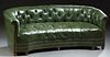 English Style Green Leather Chesterfield Sofa, 20th c., the curved tufted leather back and arms over a tufted concave seat, with iro...