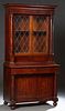 American Classical Mahogany Bookcase Cupboard, 20th c., the stepped ogee crown above leaded glazed double doors over two deep drawer...