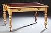 English Carved Pine Writing Table, 19th c., the rounded edge and corner top with an inset gilt tooled leather top, over a long friez...