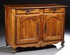 French Provincial Louis XV Style Carved Walnut Sideboard, 19th c., the rounded corner top over two frieze drawers, above double cupboar