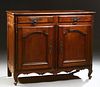 French Provincial Louis XV Style Carved Walnut Sideboard, 19th c., the stepped rounded corner top over two frieze drawers and double...