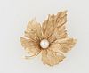 14K Yellow Gold Leaf Brooch, 20th c., the center with a 6 mm round cultured pearl, H.- 1 1/4 in., W.- 1 5/8 in., D.- 1/2 in. Wt.- .2...