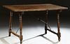 Spanish Provincial Carved Walnut Kitchen Table, 19th c., the rectangular top on turned and block trestle supports, joined by wrought...