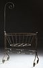French Wrought Iron Cradle, 19th c., with a mosquito netting hook on one end, with canted rod sides, H.- 71 in., W.- 42 in., D.- 22...